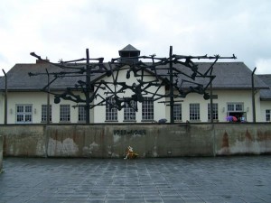 An art memorial depicting intertwined bones and bodies adorns the exterior of the Dachau Concentration Camp museum.  (photo by Sara Tallerico)